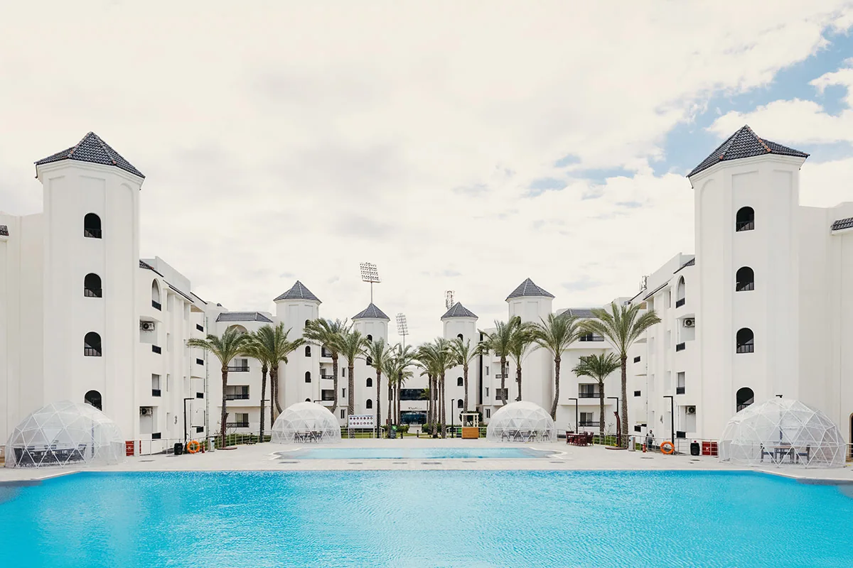 Pool courtyard and white buildings at Palma Hotel in Port Said